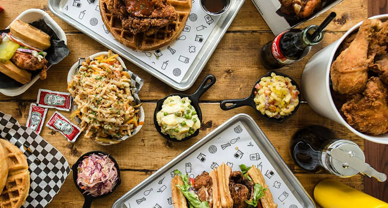 Dirty Bird fried chicken and waffle sandwich fries coke drumsticks coleslaw sides mac and cheese